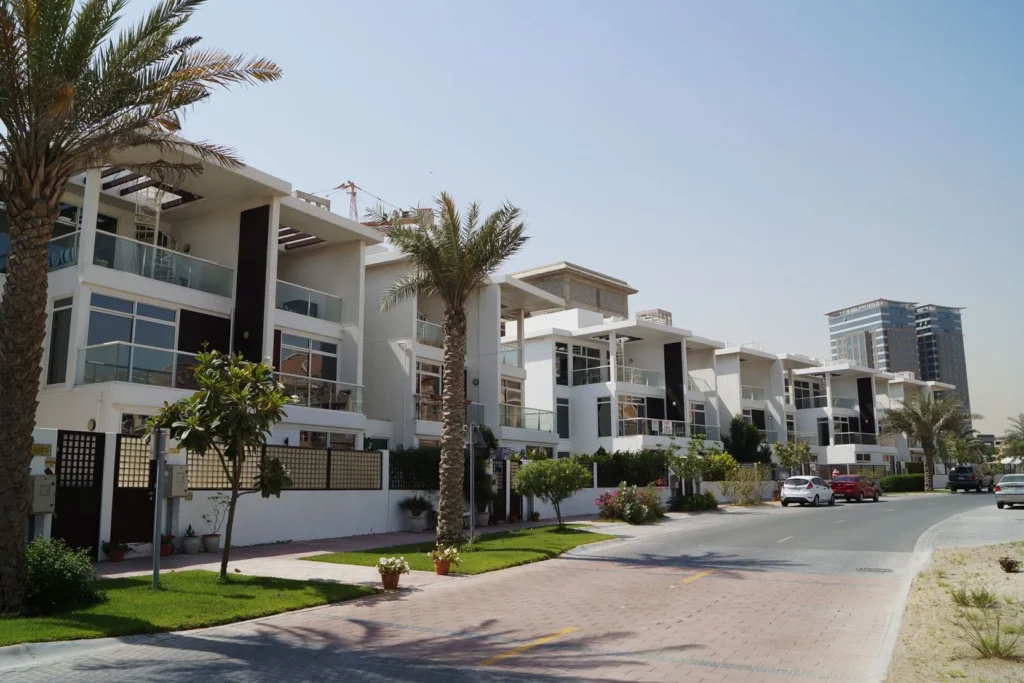 Modern villas in a gated community with palm trees and scenic views at Dubai Investment Properties event.