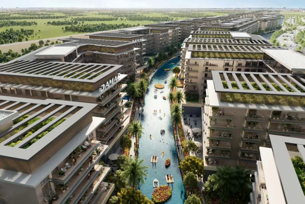 Damac’s luxury apartment buildings at Dubai Investment Properties, offering views of lush green spaces and a beautiful lagoon.